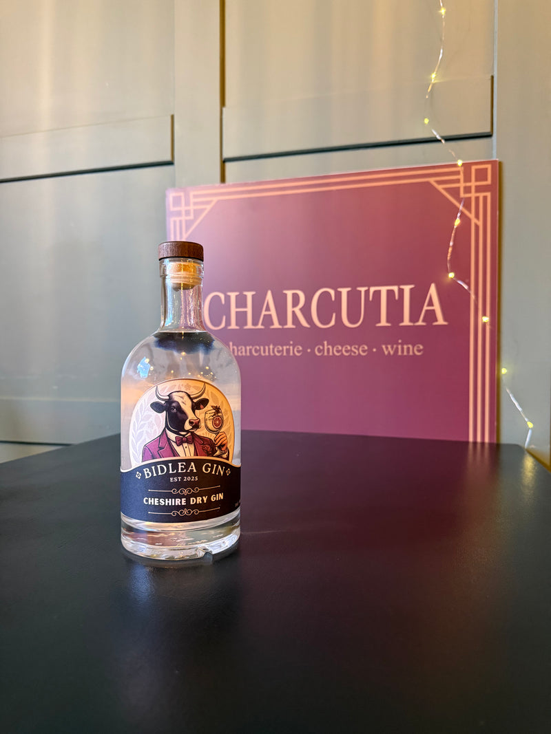 Bottle of Bidlea Gin on a dark surface with 'Charcutia' in the background